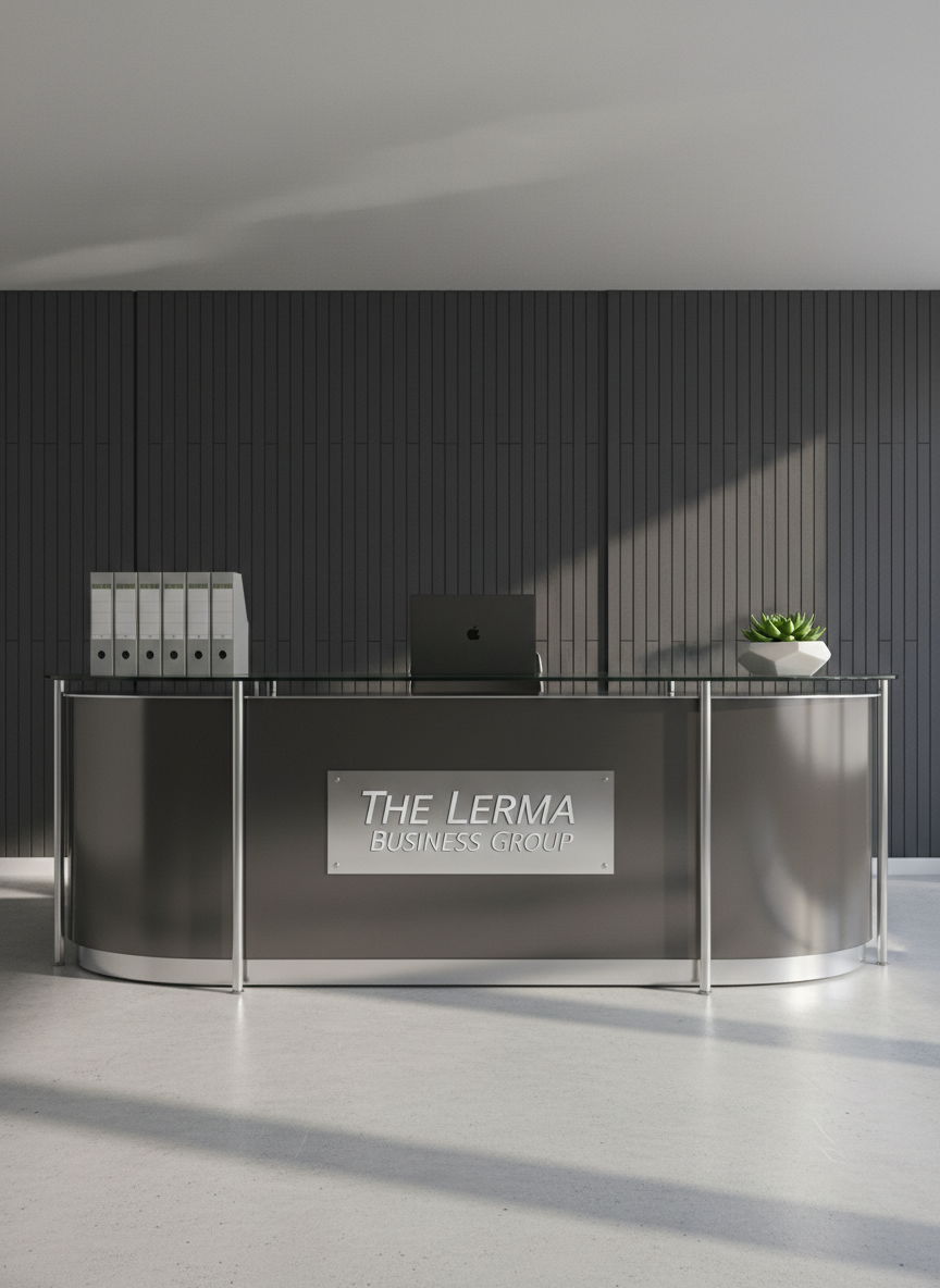 A sleek glass-and-metal office reception desk bearing a polished silver logo plaque reading “The Lerma Business Group,” set against a dark charcoal textured wall with subtle vertical lines. On the desk, a minimalist arrangement of organized file folders, a closed matte-black laptop, and a small geometric planter with a lush green plant suggest multiple professional services. Soft, even studio-style lighting washes the scene, creating crisp reflections on the glass and gentle shadows beneath the desk. Photographic realism, captured at eye level with a slightly wide angle, emphasizes depth and space. The mood is confident and professional, with a clean, modern aesthetic that feels suitable for a high-end, multi-service business firm homepage hero image.
